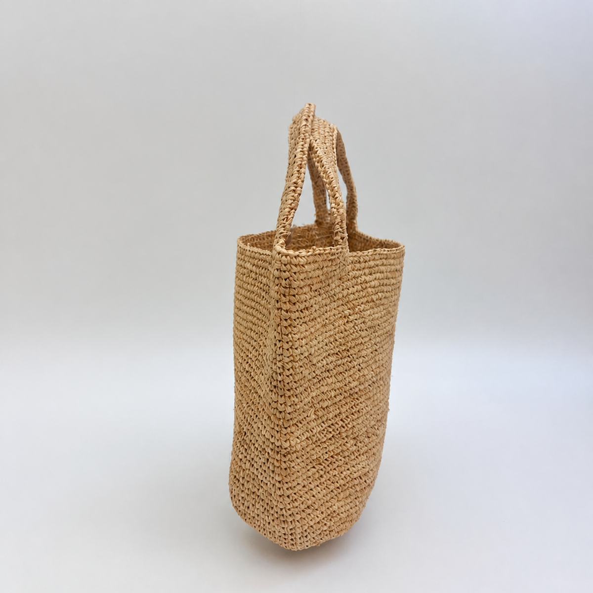 Isla Raffia Straw Clutch — side view of Tiger Canada handwoven raffia bag