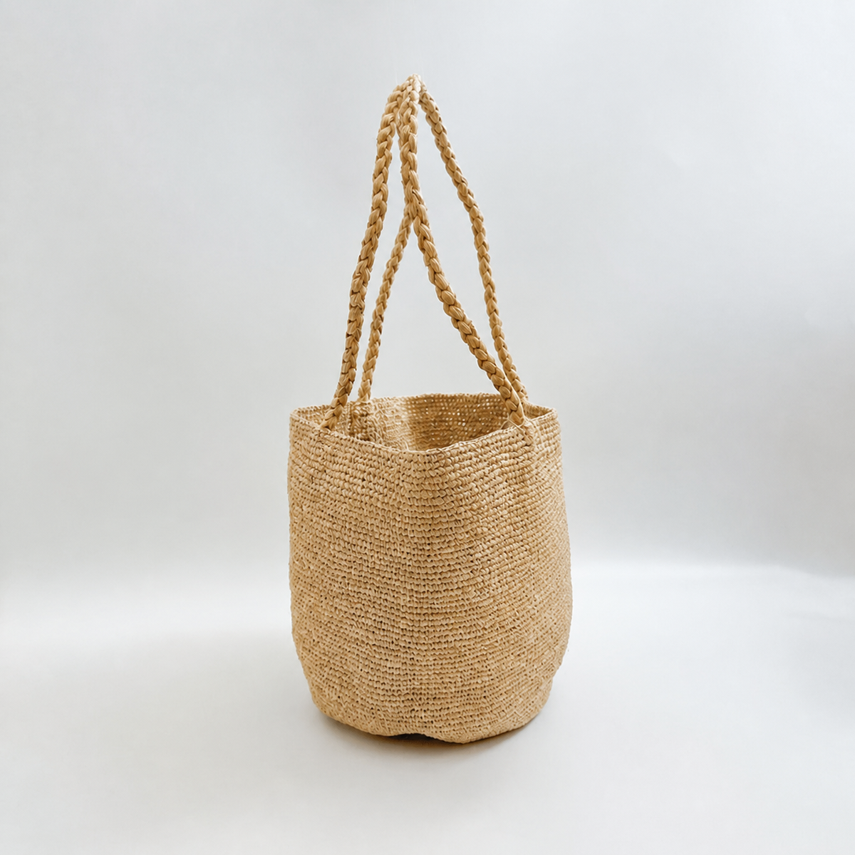 Moira Minimalist Raffia Bucket Bag — side view of Tiger Canada handwoven raffia bag