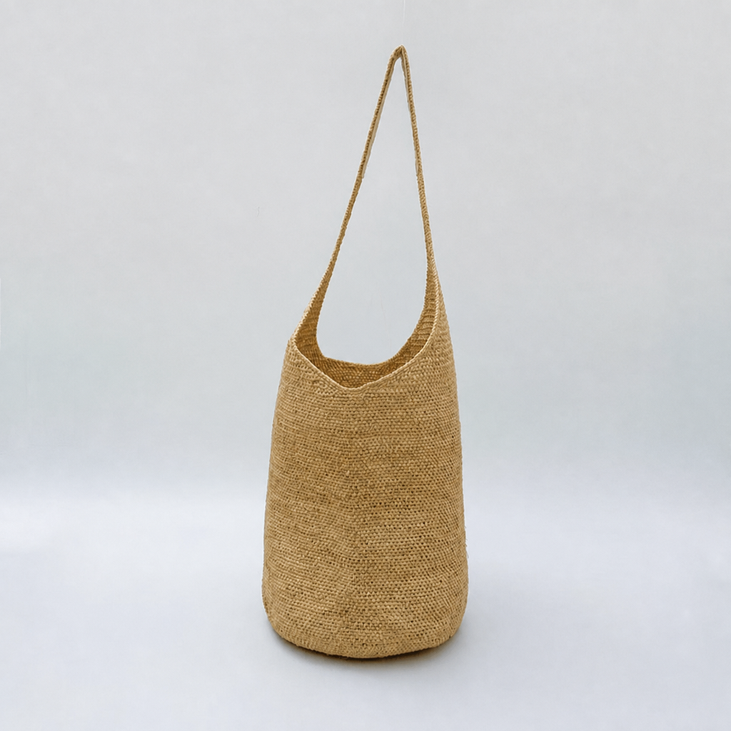 Drift Lightweight Raffia Bucket Bag — side view of Tiger Canada handwoven raffia bag