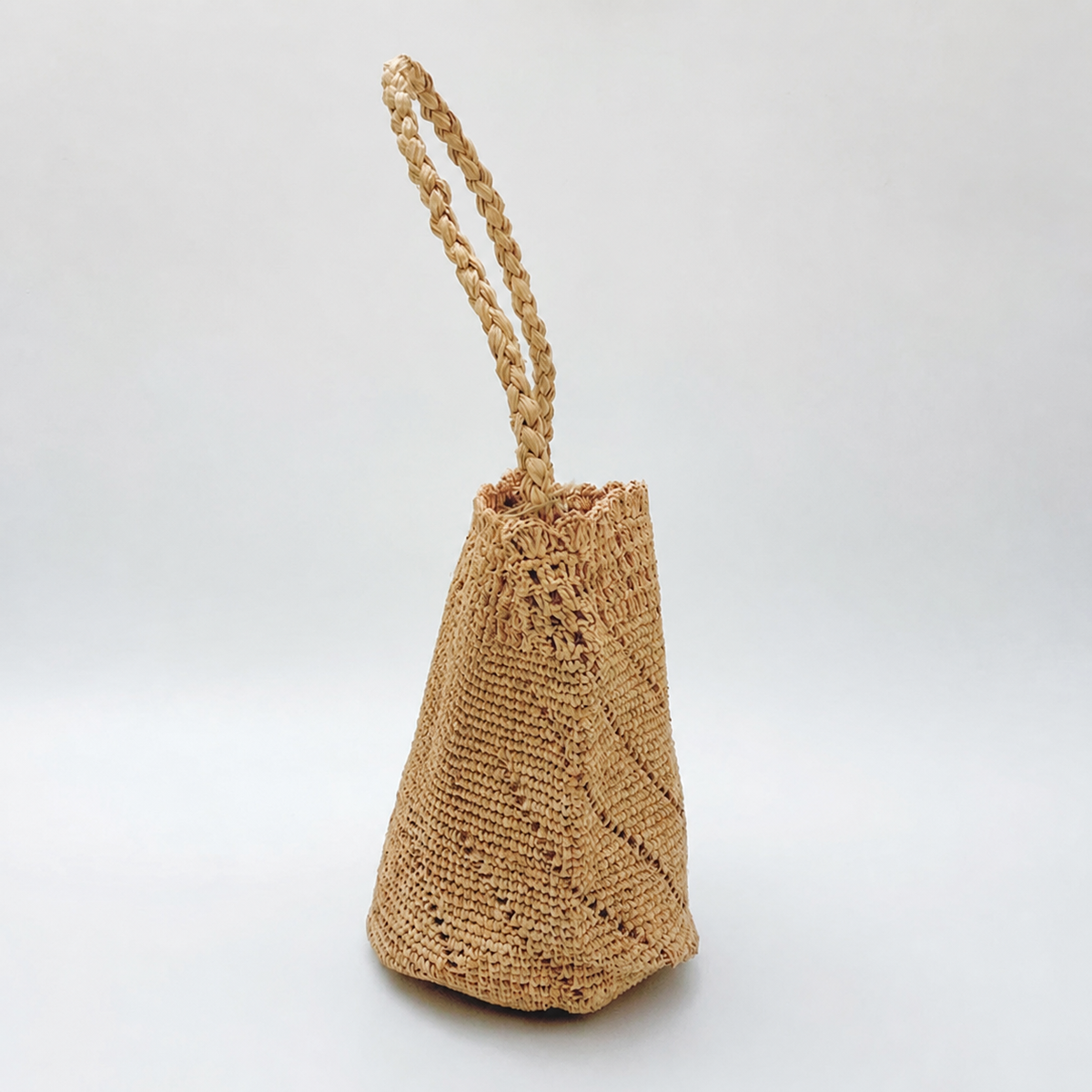 Celeste Raffia Bucket Bag — side view of Tiger Canada handwoven raffia bag